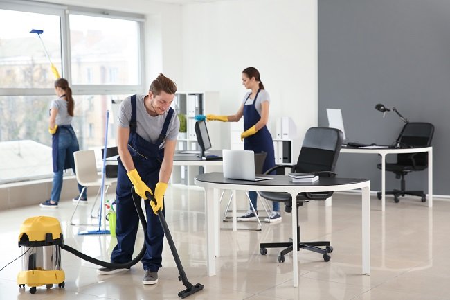 Home team of janitors cleaning office