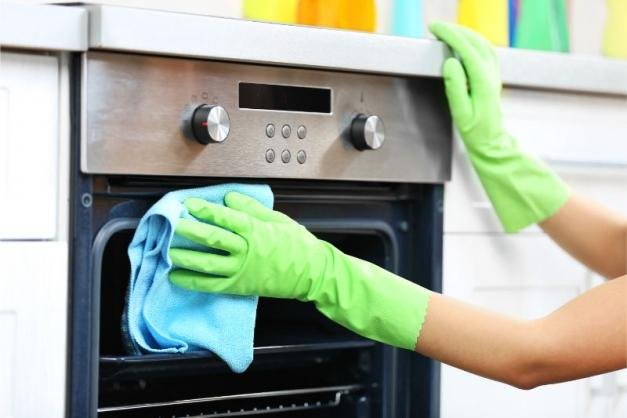 shutterstock woman hands protective gloves cleaning oven 391063411